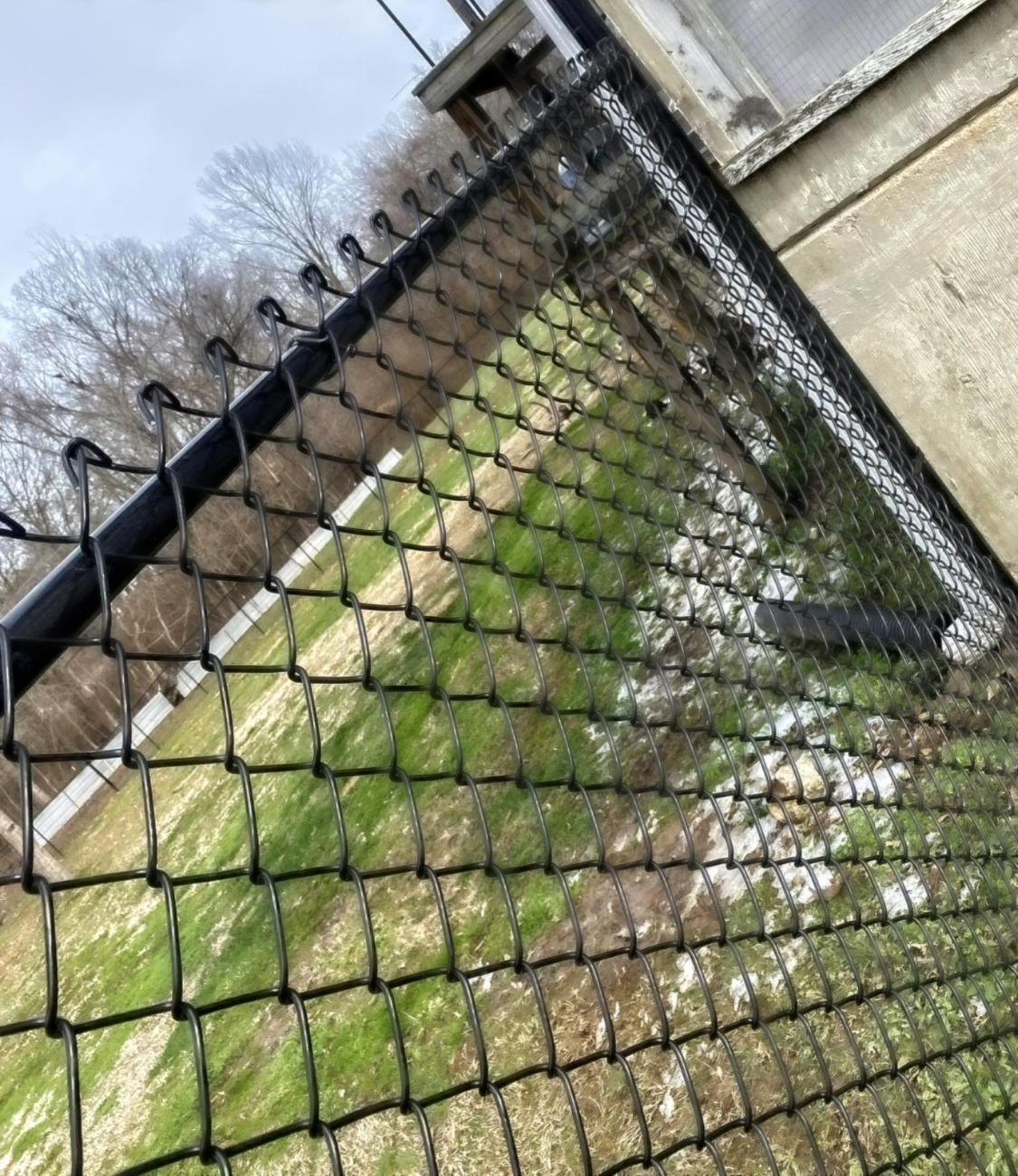 Black commercial chain link running along a concrete wall.